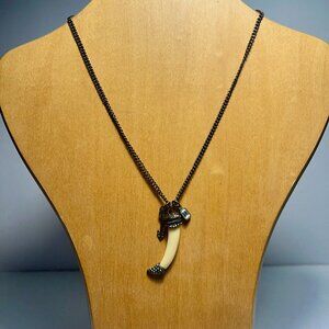 Dark Chain Featuring Tusk-Shaped Object with Arrow Charm and a Clear Gem.